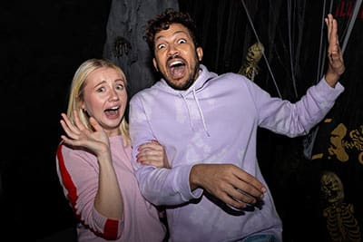 couple scared in haunted house